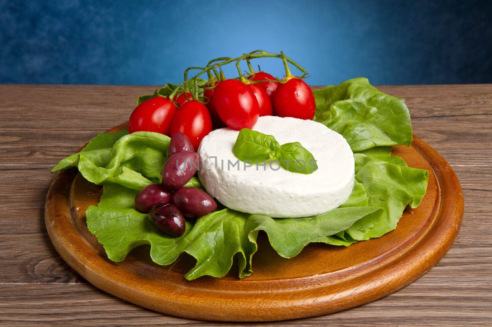 fresh cheese with salad, tomatoes and black olives