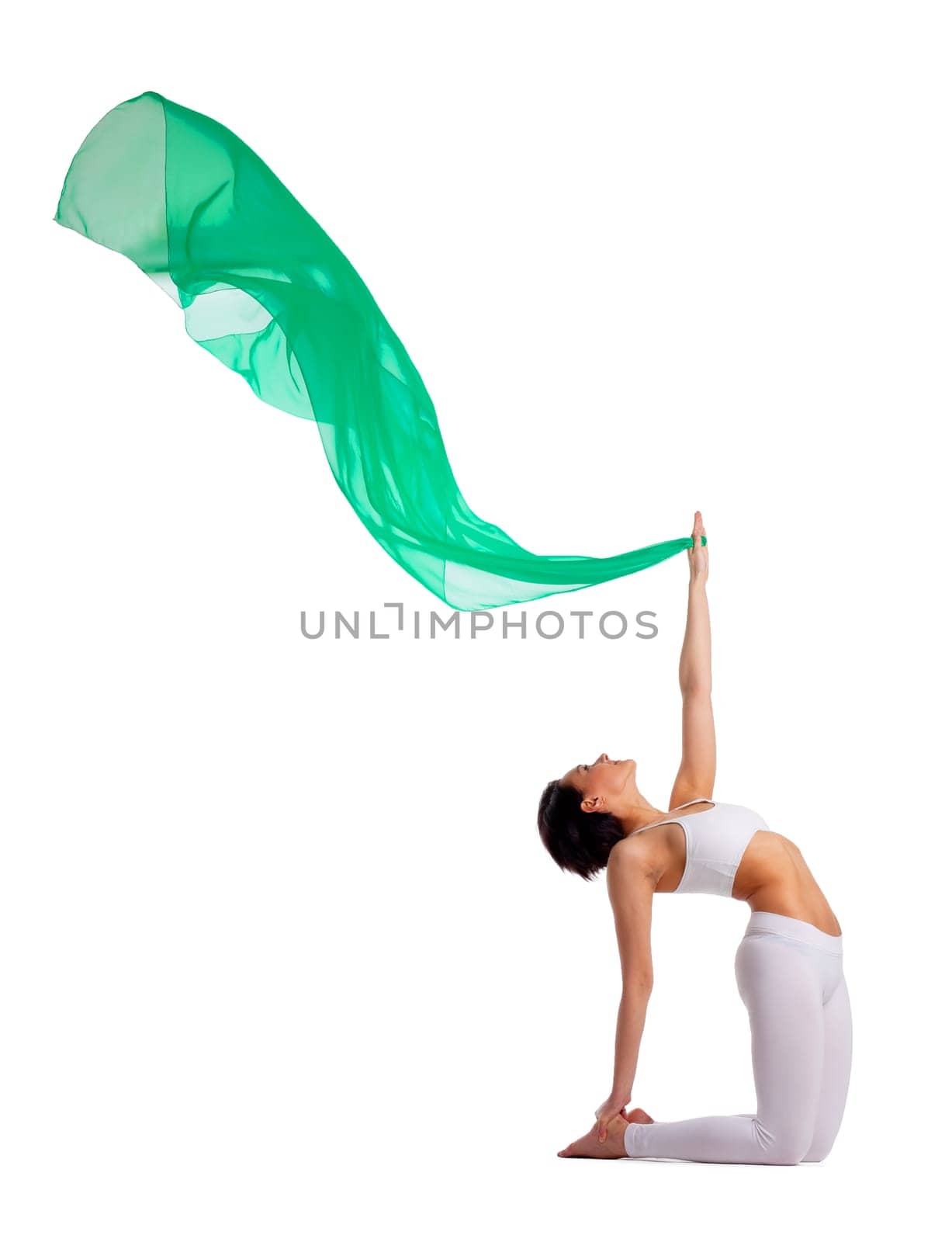 woman in yoga camel pose with green fluing veil in air isolated