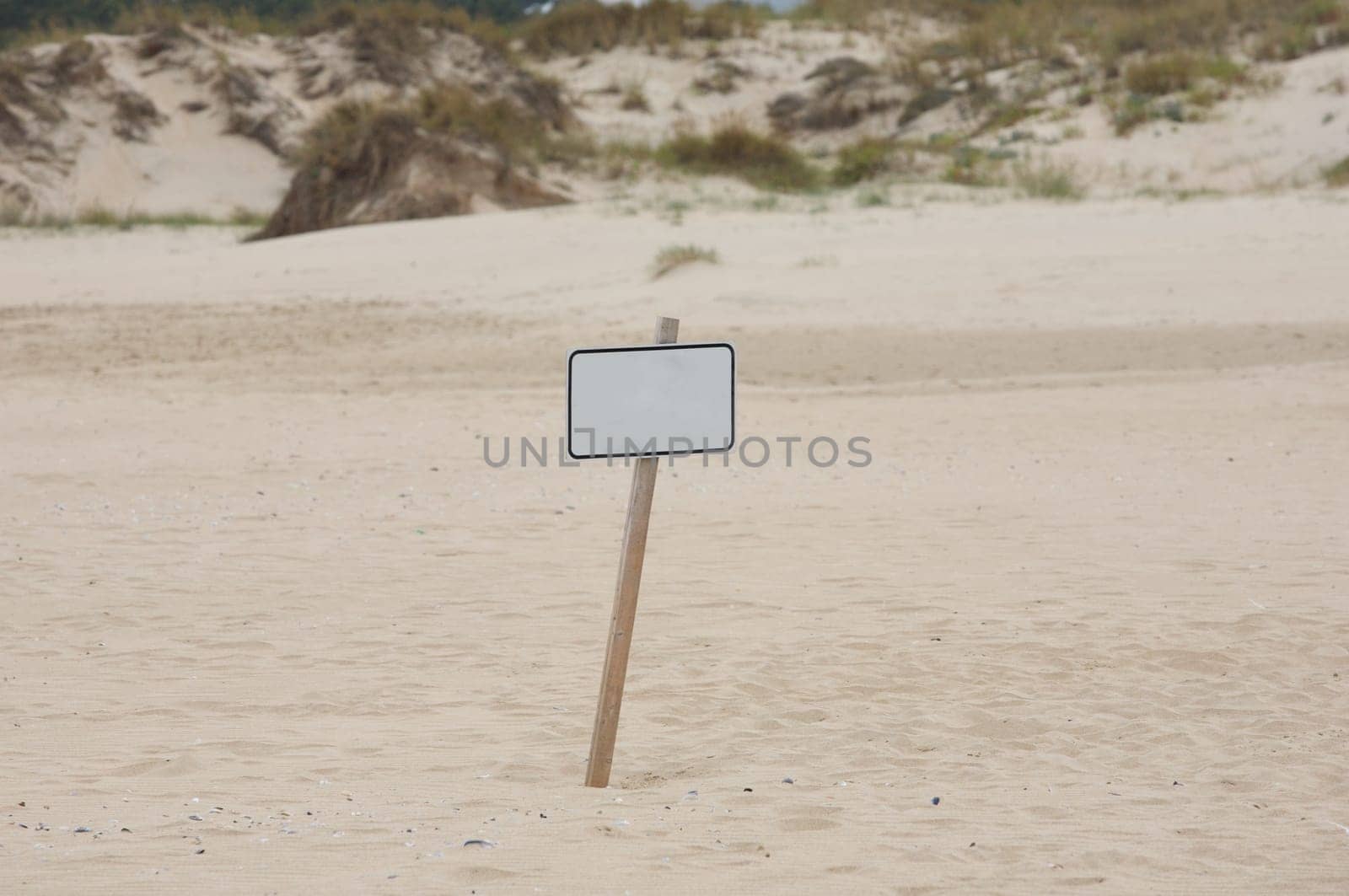 Lonely poster in the middle of the sand