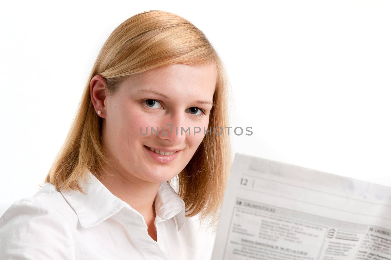 Young woman reading the newspaper