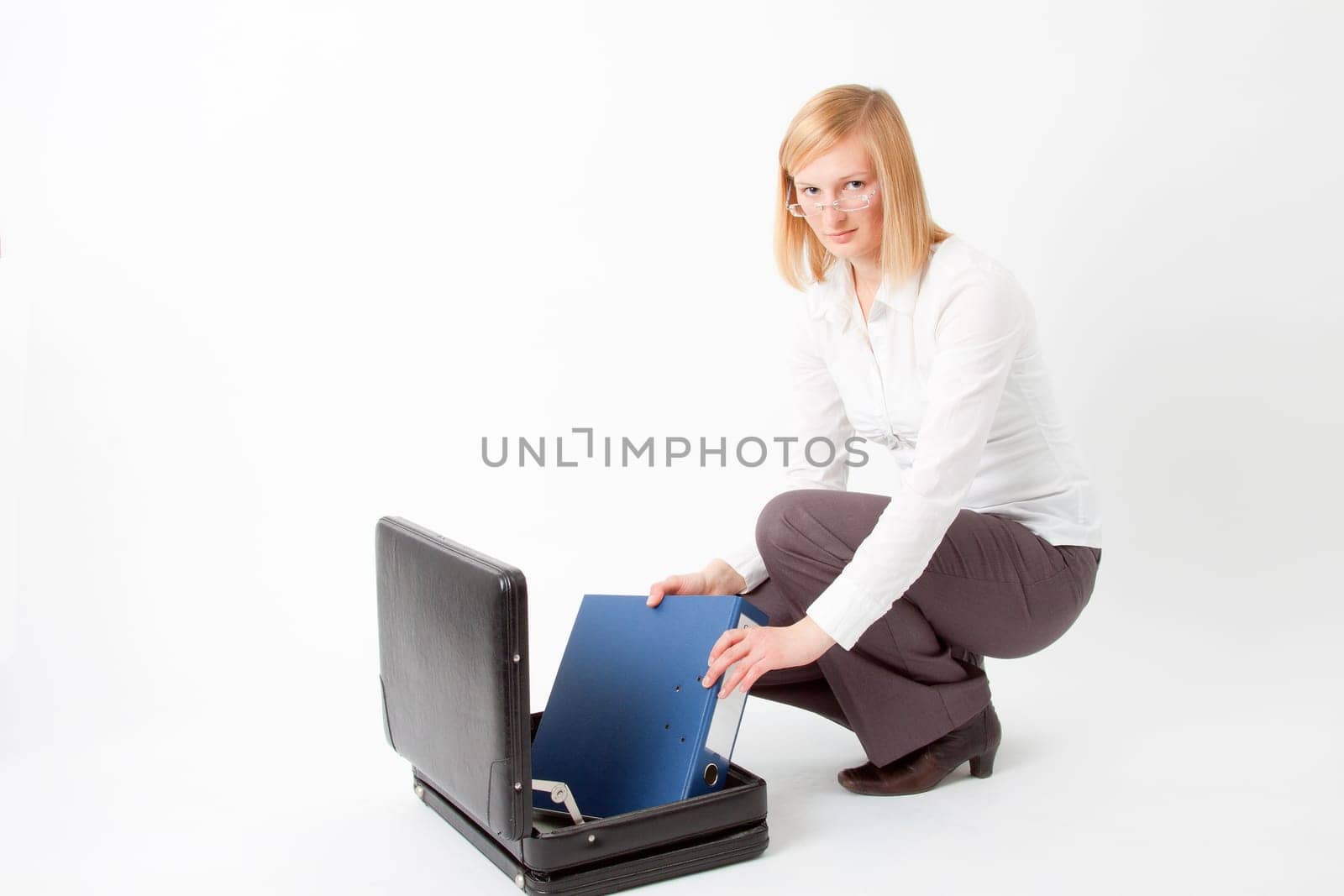 Young woman with briefcase and folder