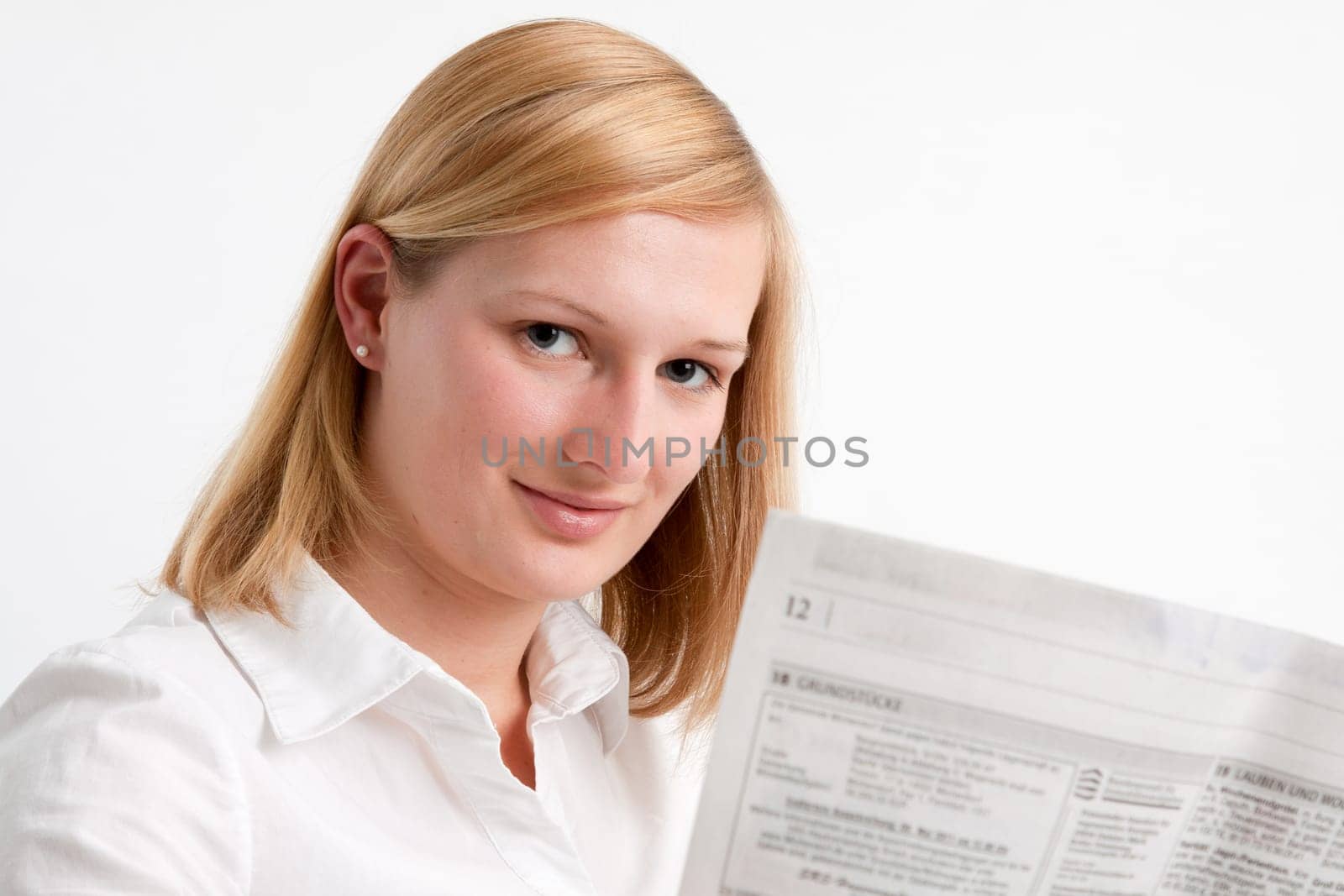 Young woman reading the newspaper