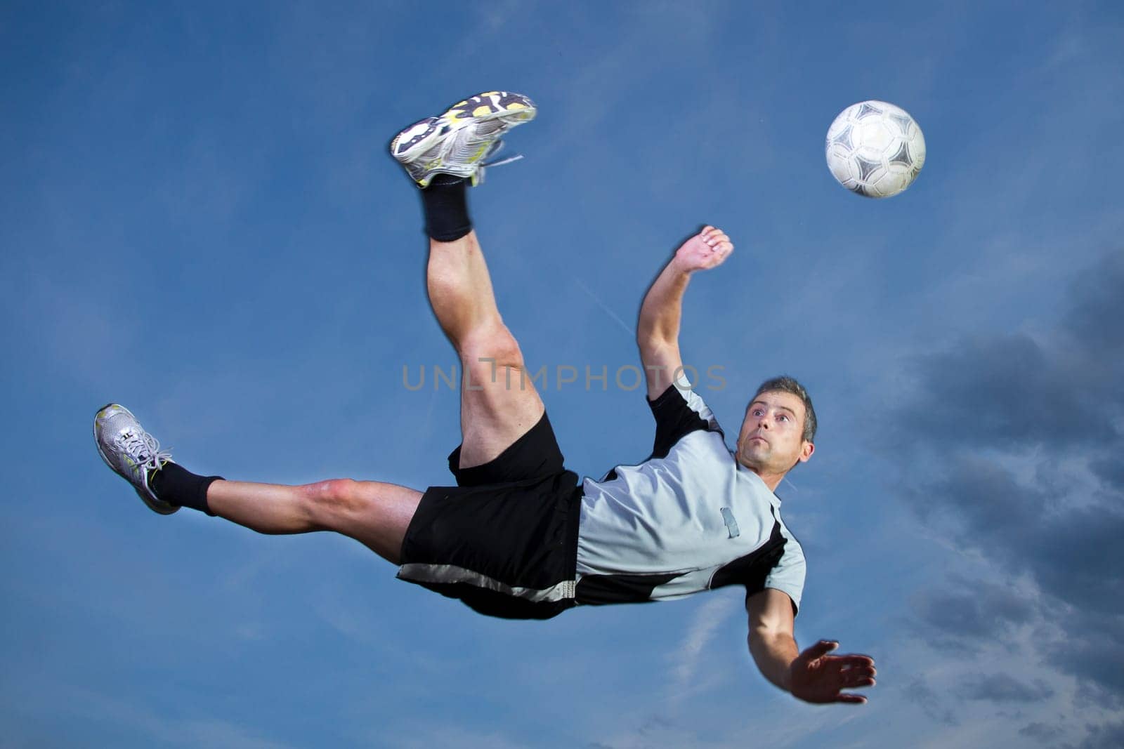 Footballers taking a overhead kick