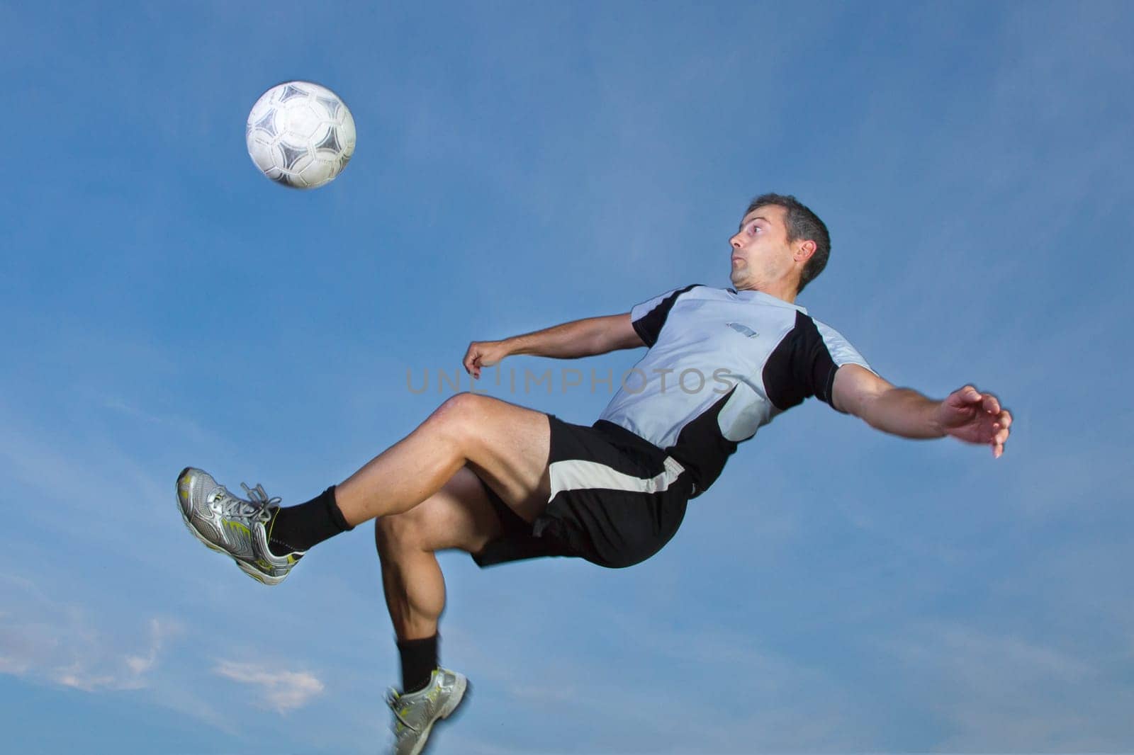 Footballers taking a overhead kick