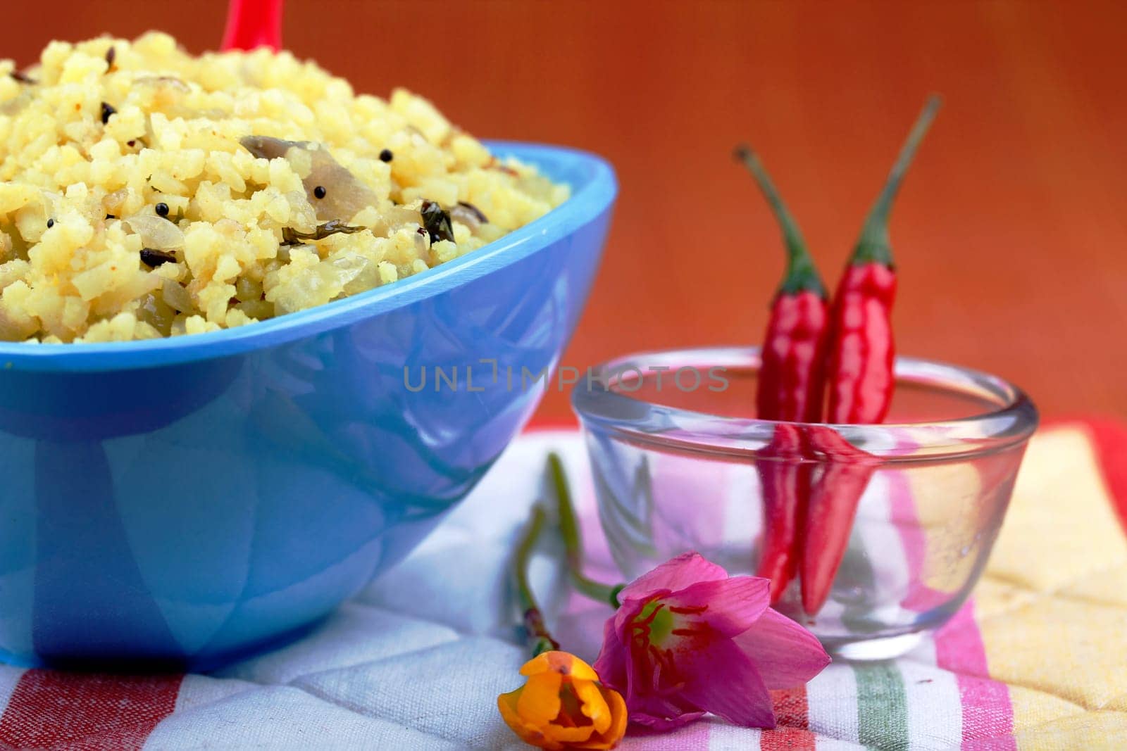Indian saffron rice dish with chili and flowers