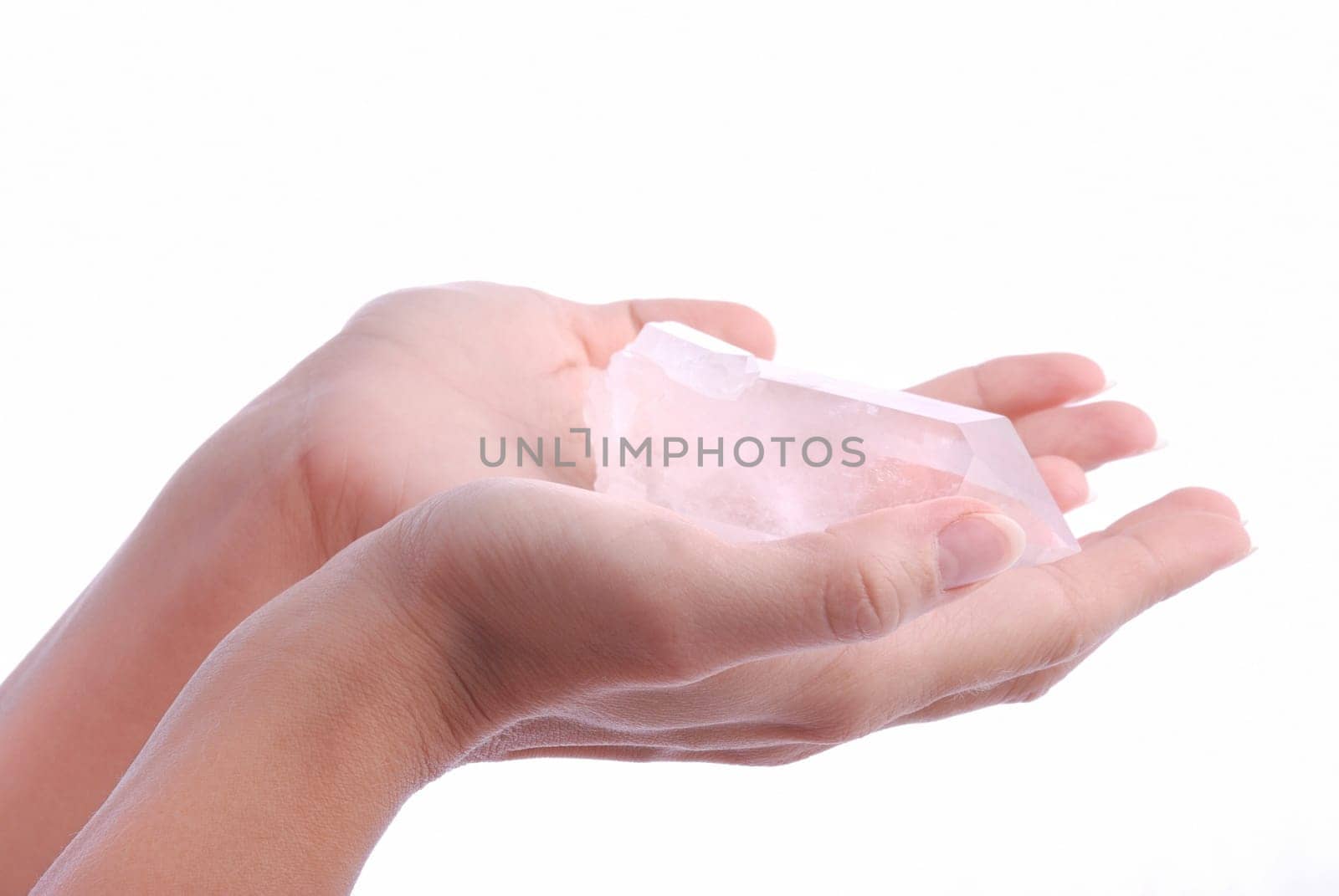 Hands holding quartz - semiprecious gems are  used in esoteric and alternative medicine