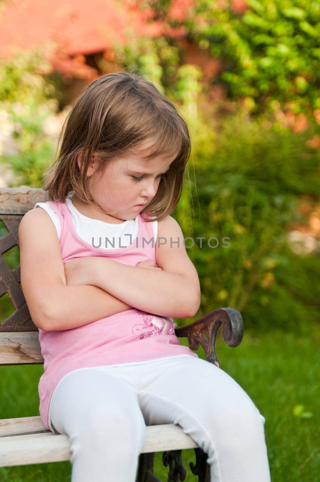 Outdoors portrait of small cute girl with offended look