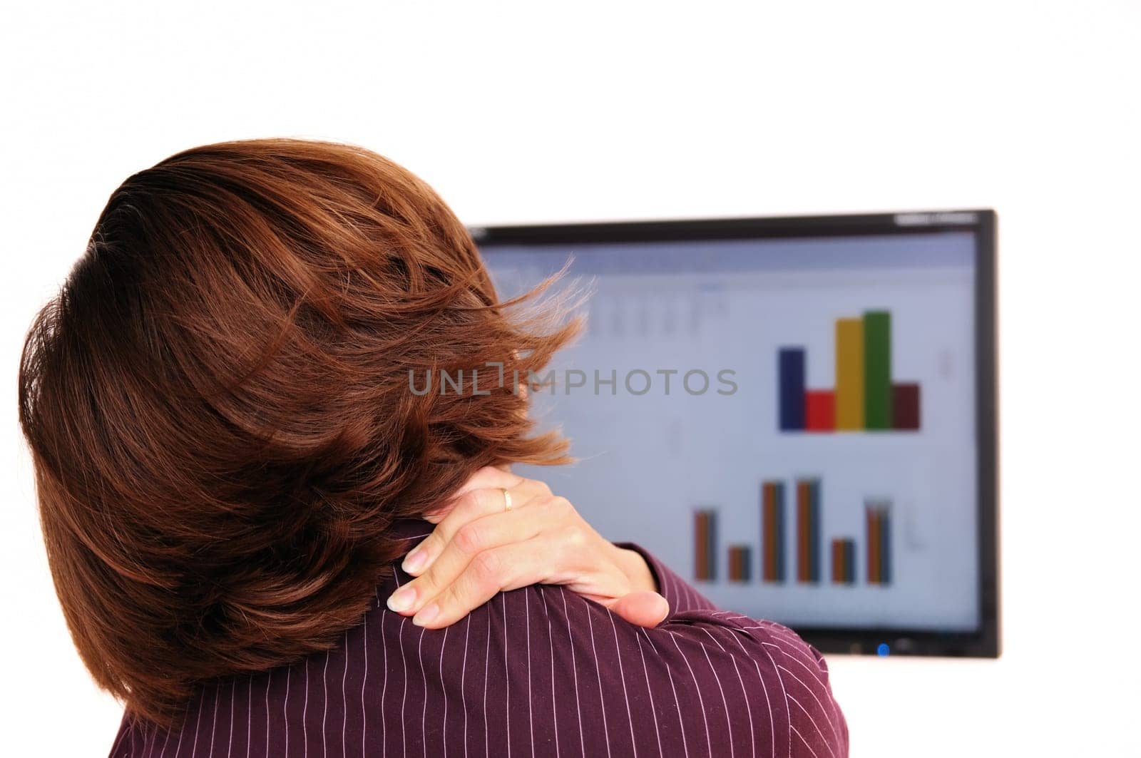 Business person with neck pain behind computer monitor