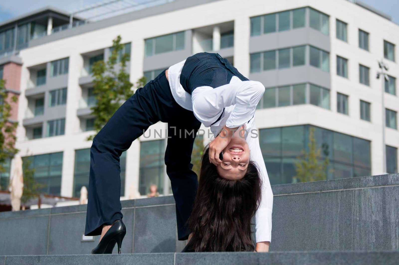Communication concept - young smiling flexible business woman calling cellphone