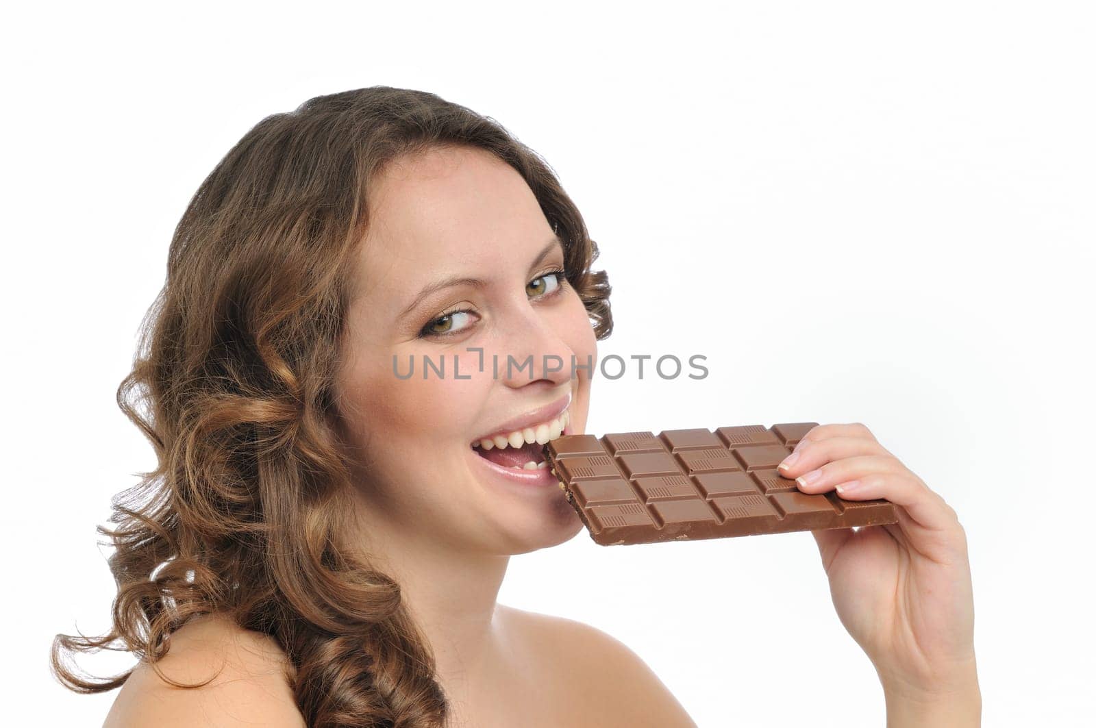 Young beautiful smiling woman eating milk chocolate isolated on white background