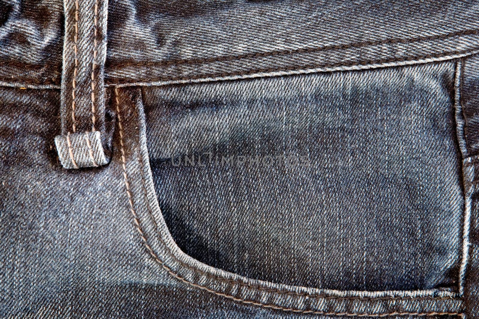Photo of a pocket jeans with yellow thread