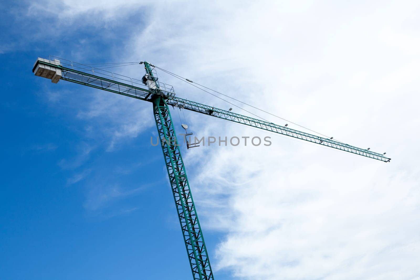 Huge construction crane with cloudy sky background