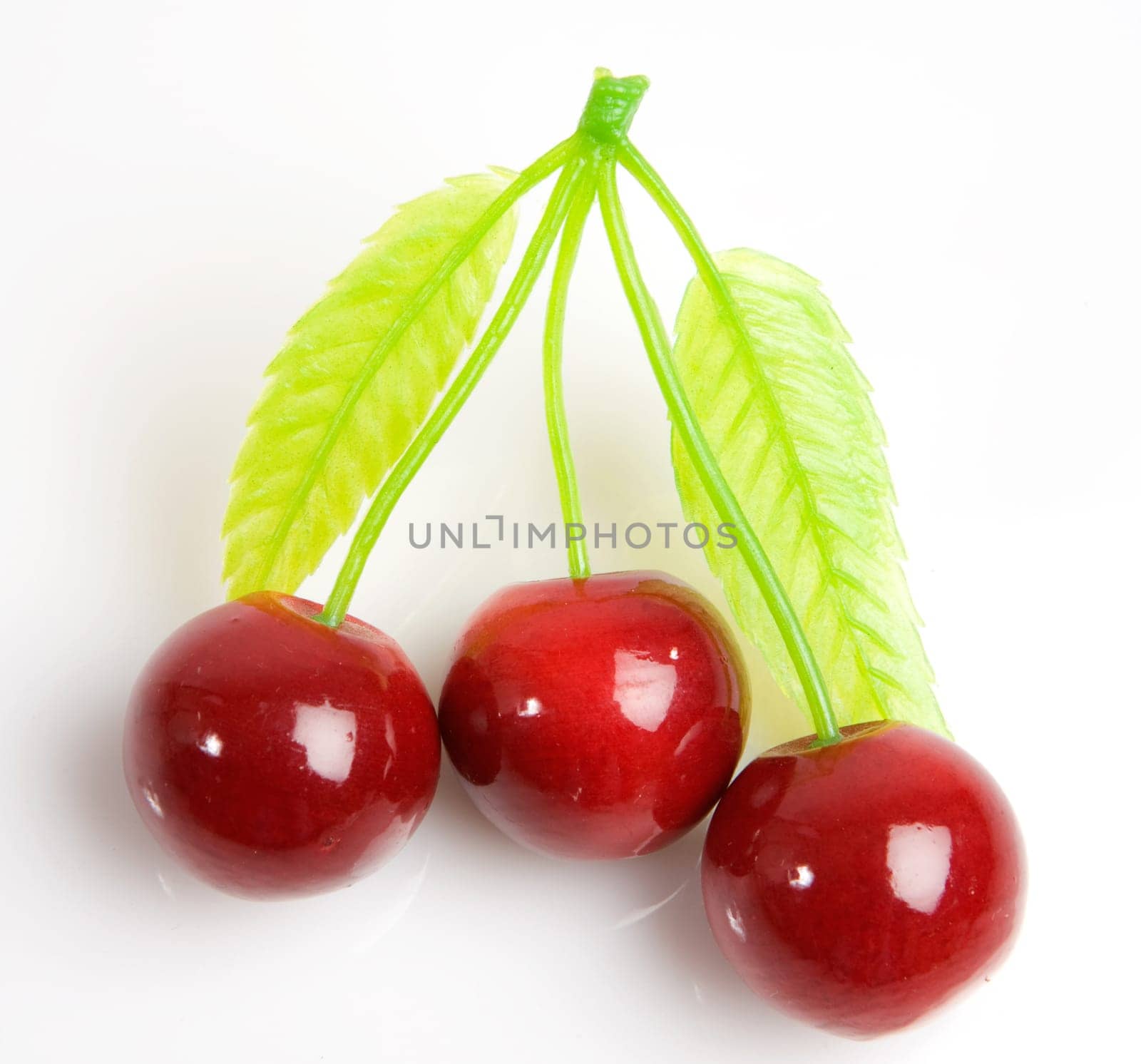Three red cherries a over white background