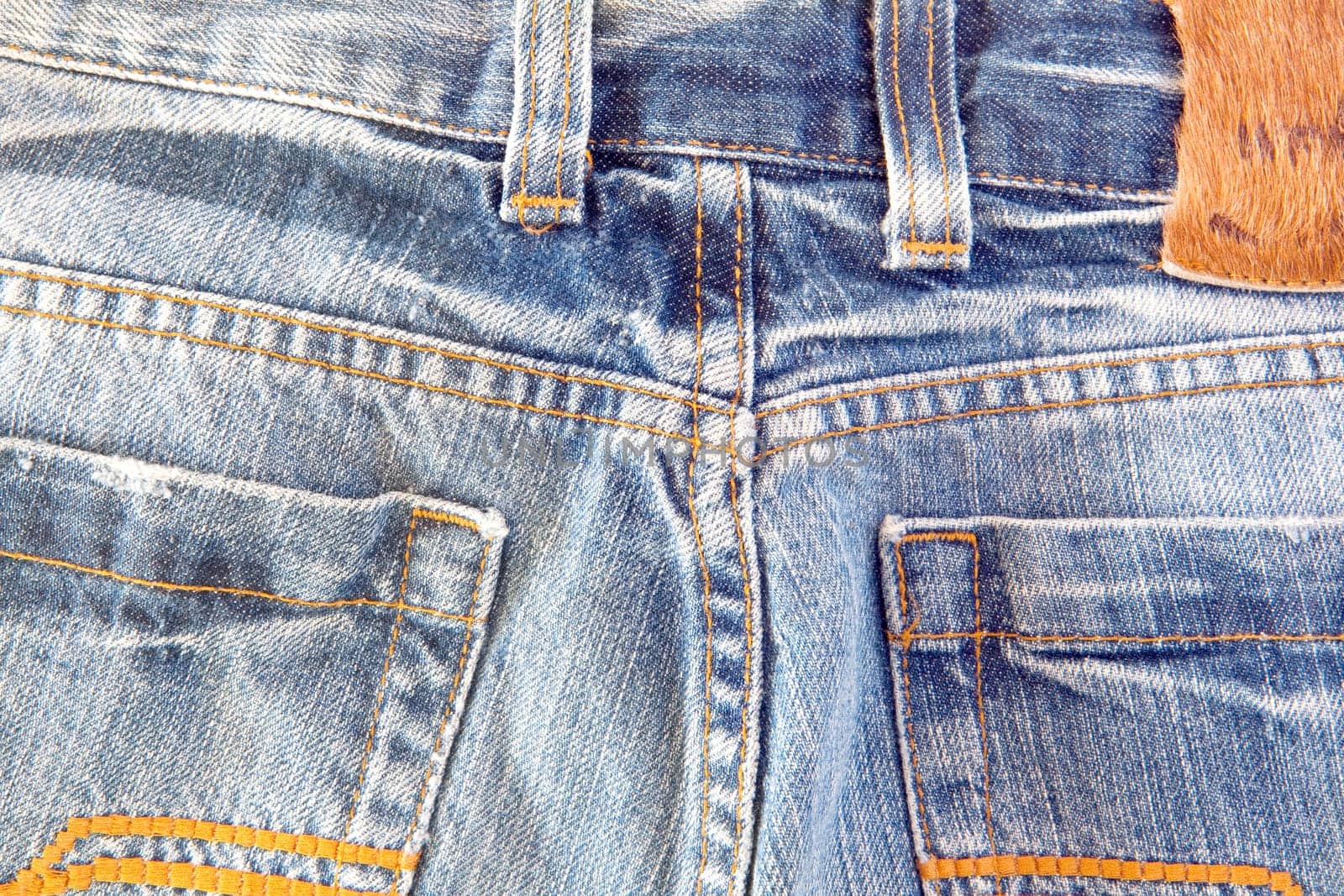 Photo of a pocket jeans with yellow thread