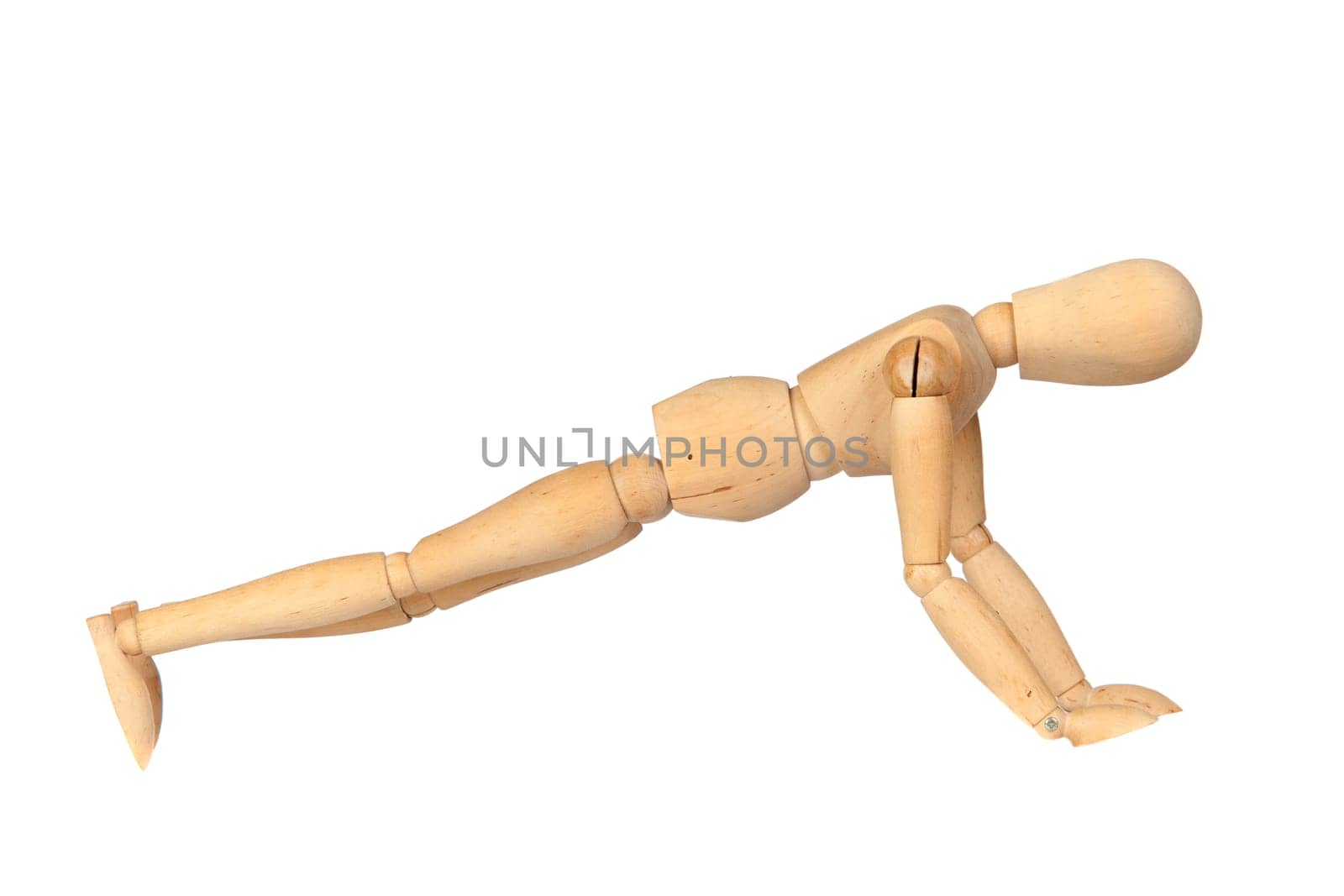 Jointed wooden mannequin doing push-ups isolated on white background