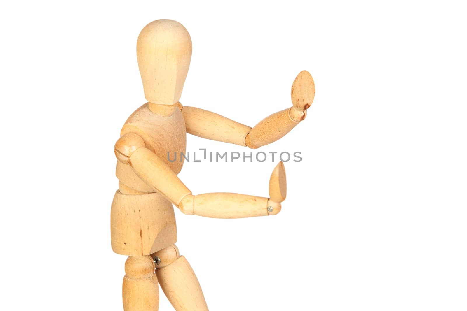 Jointed wooden mannequin pushing something isolated on white background
