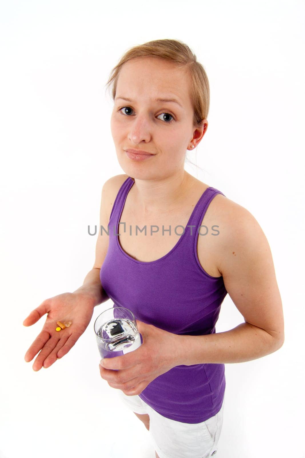 Young woman taking pills