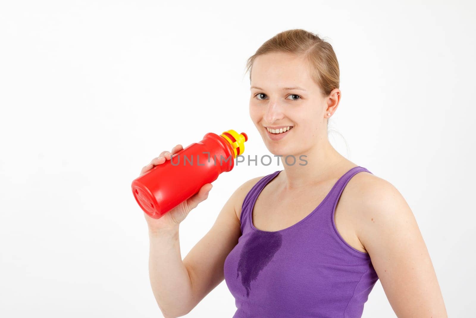 Young woman drinking from a drinking bottle