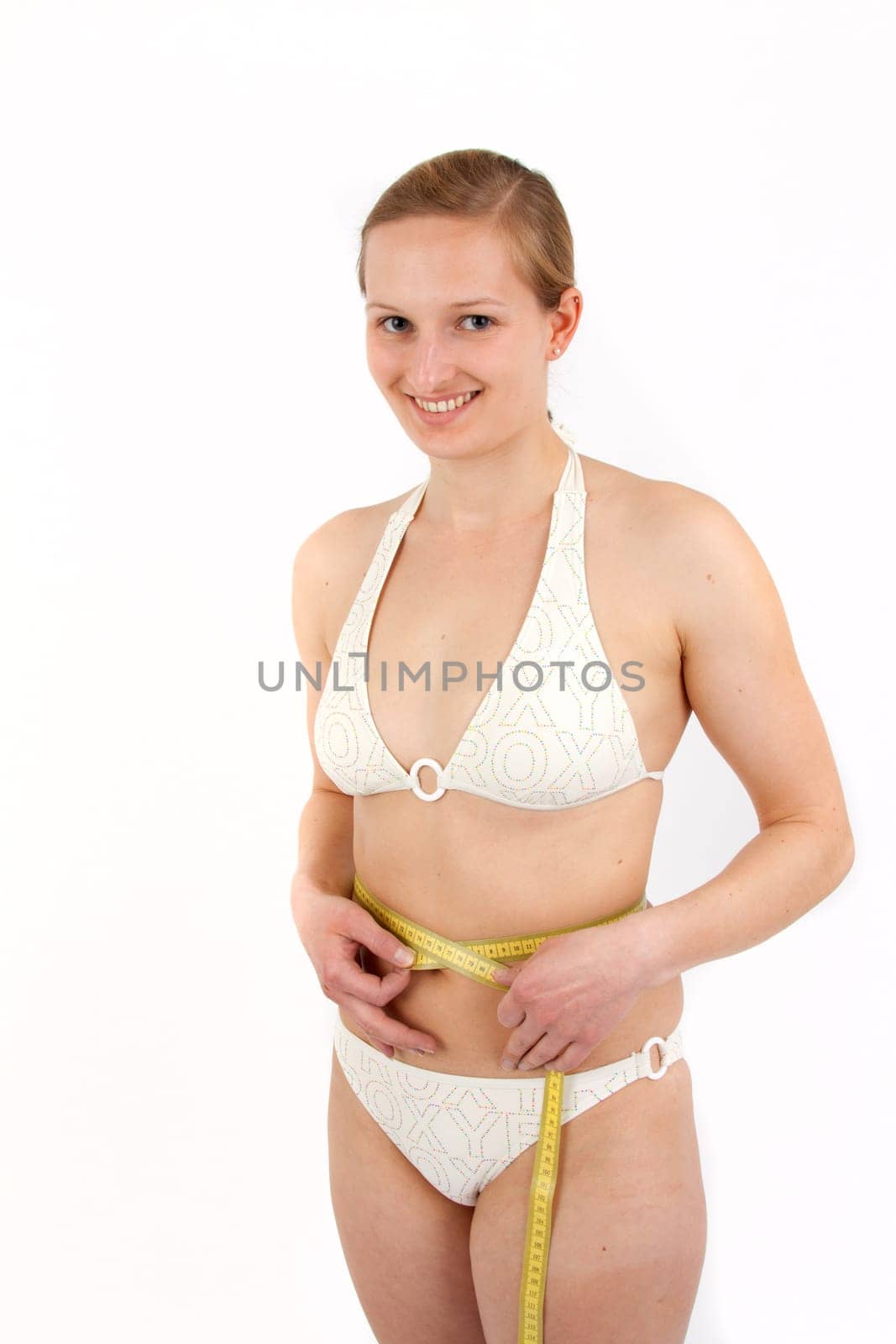 Young woman measuring her abdominal circumference