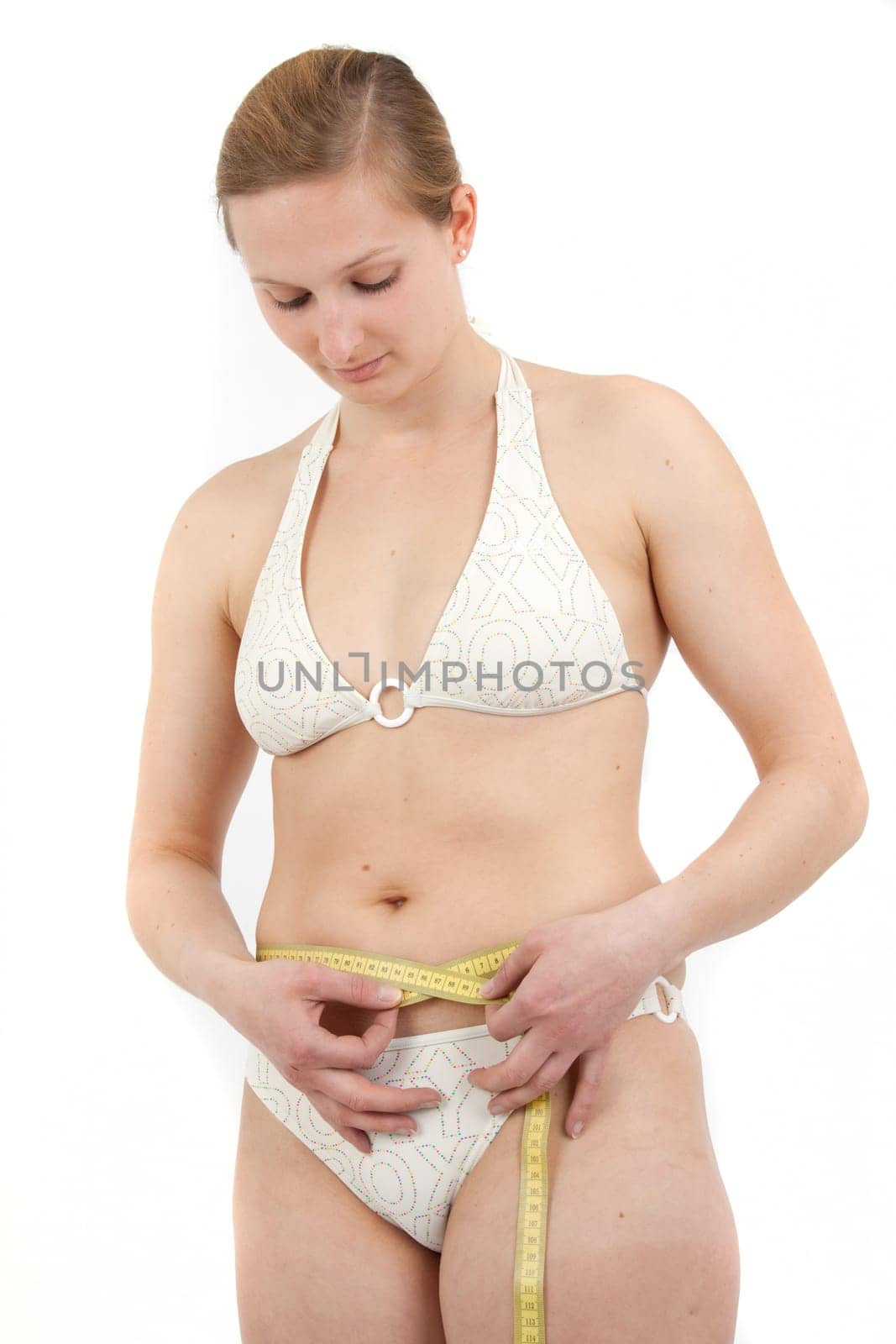 Young woman measuring her abdominal circumference