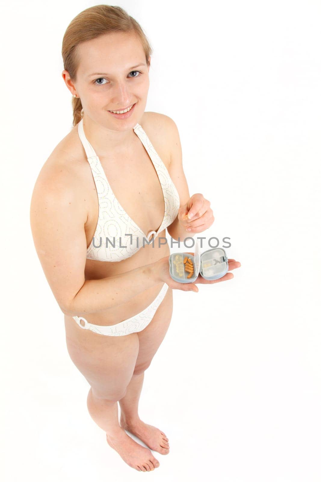 Young woman with pill box before taking
