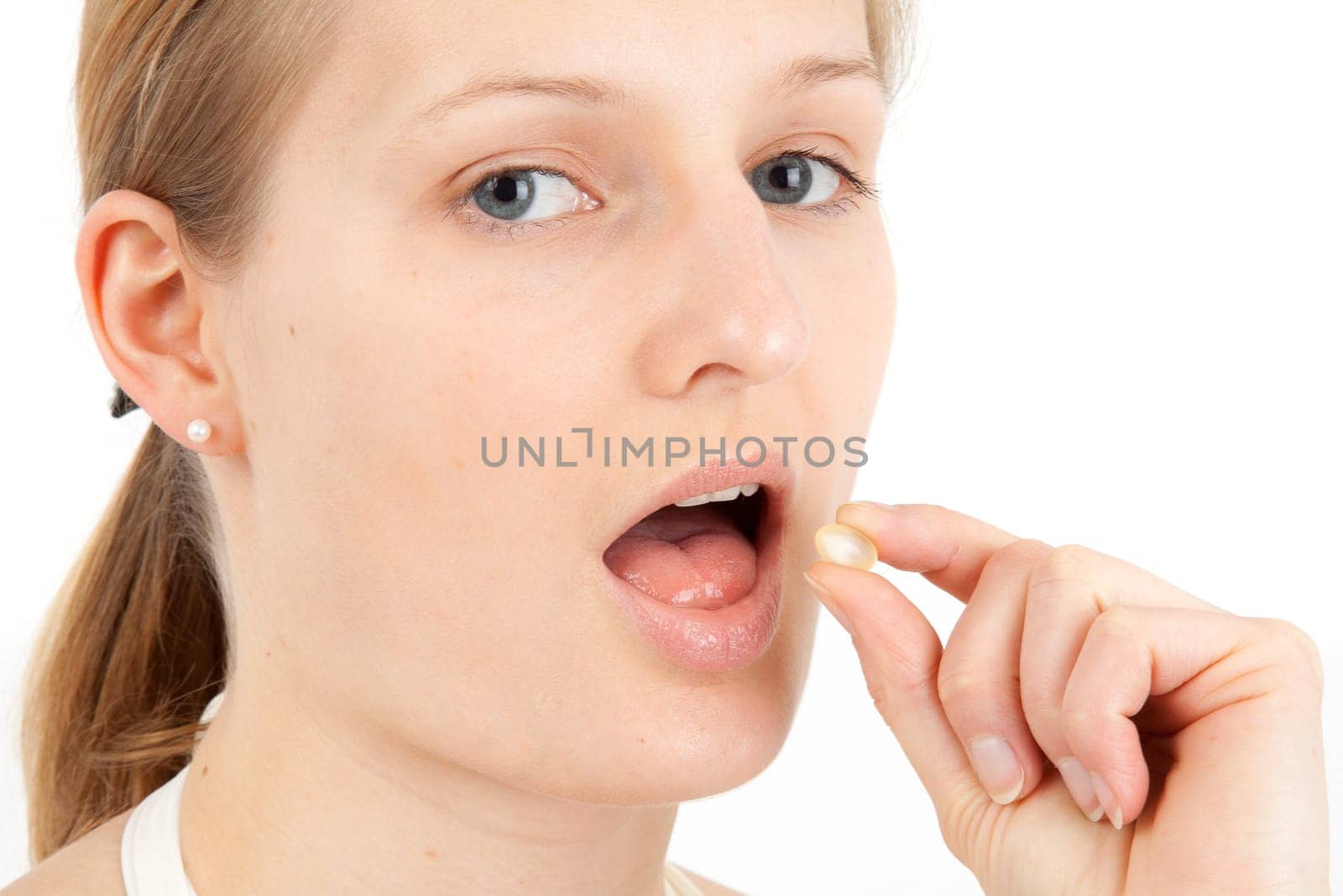 Young woman taking capsule