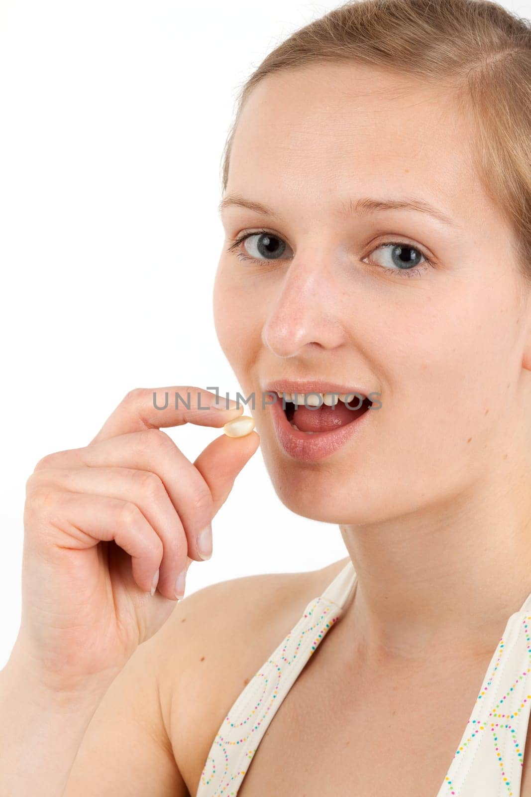Young woman taking capsule