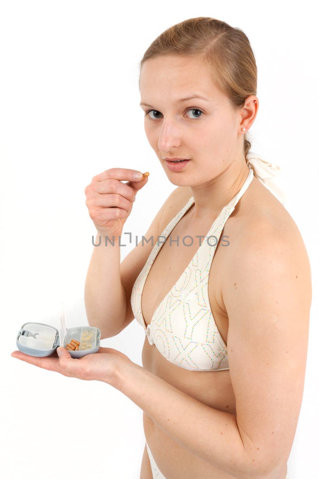 Young woman with pill box before taking