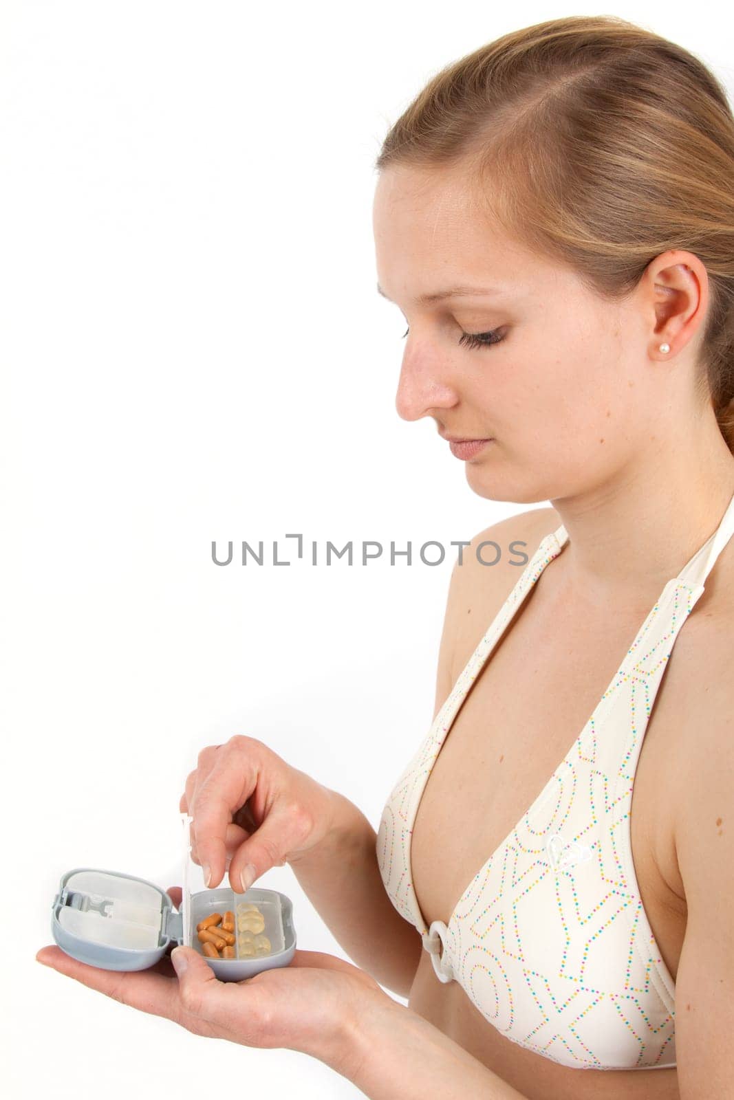 Young woman with pill box before taking