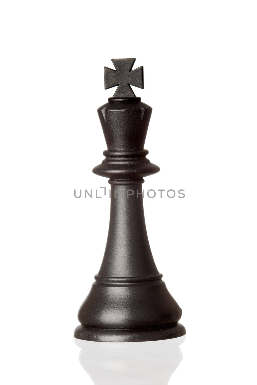 Black king chess piece isolated on white background with reflection on the floor