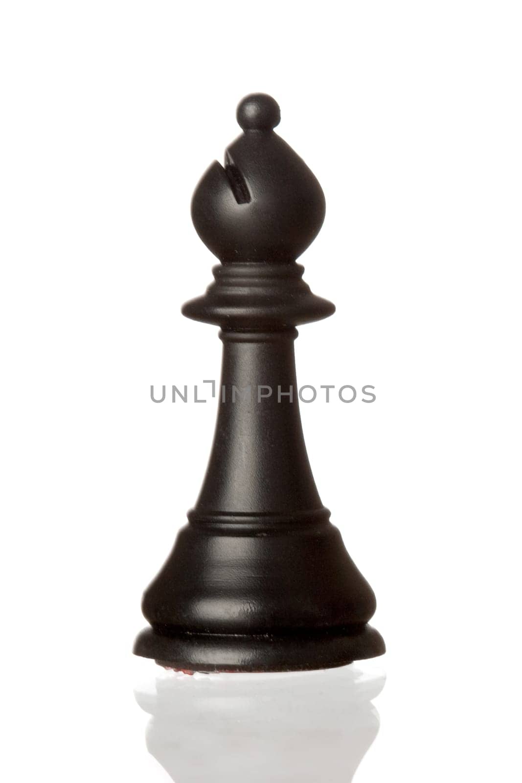 Black bishop chess piece isolated on white background with reflection on the floor