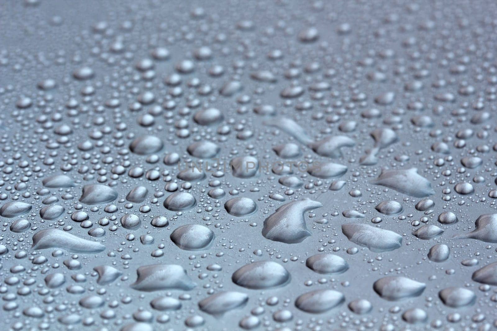 Water droplets on a shining mettallic surface