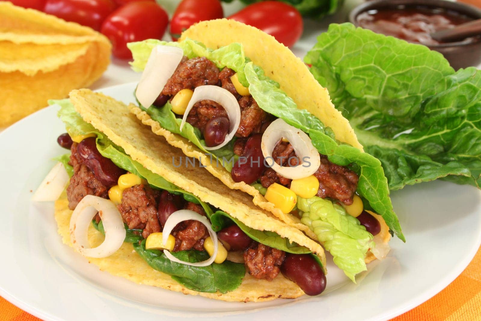 Taco shells stuffed with ground beef,kidney beans and corn