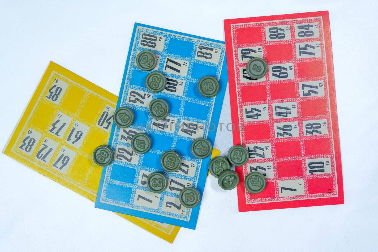 Three colorful vintage bingo cards with numbered green tokens on a white background. Classic lottery board game concept. Ideal for gambling, luck, and entertainment themes