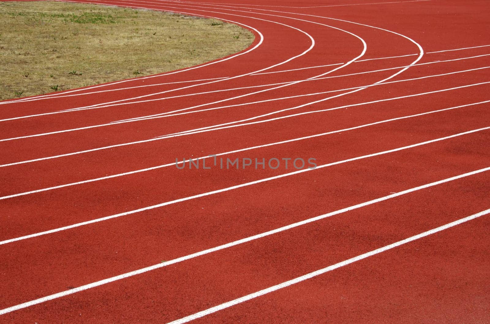 Red asphalt for runners track turn zoomed foto
