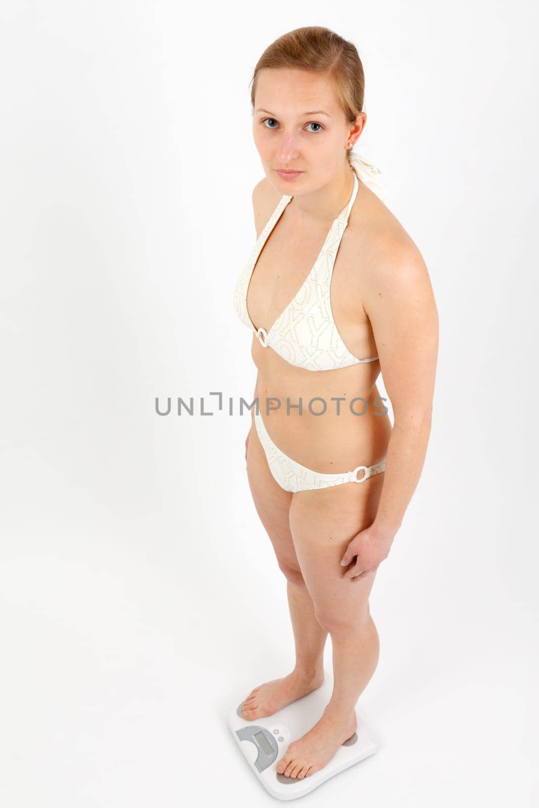 Young woman swaying on a bathroom scale