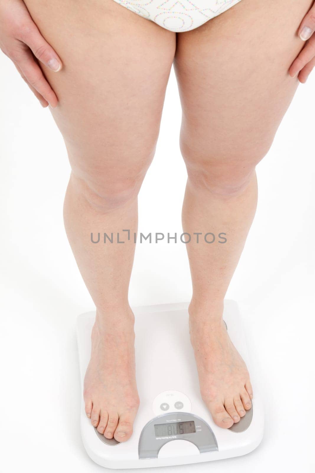 Young woman swaying on a bathroom scale