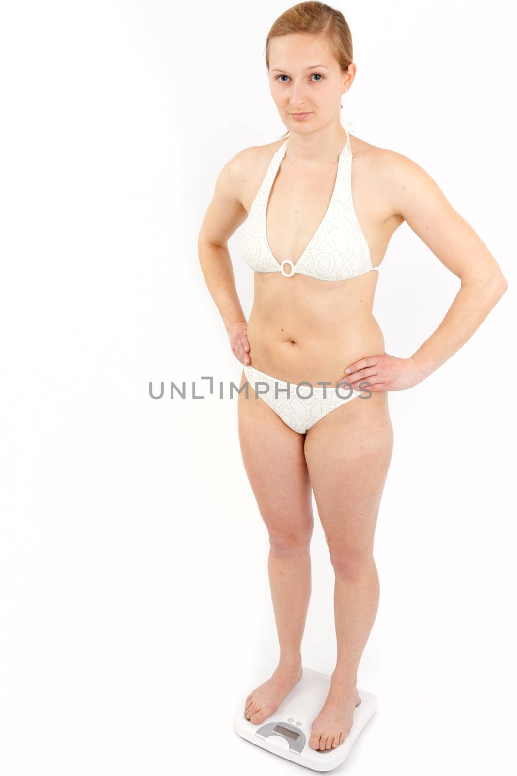 Young woman swaying on a bathroom scale