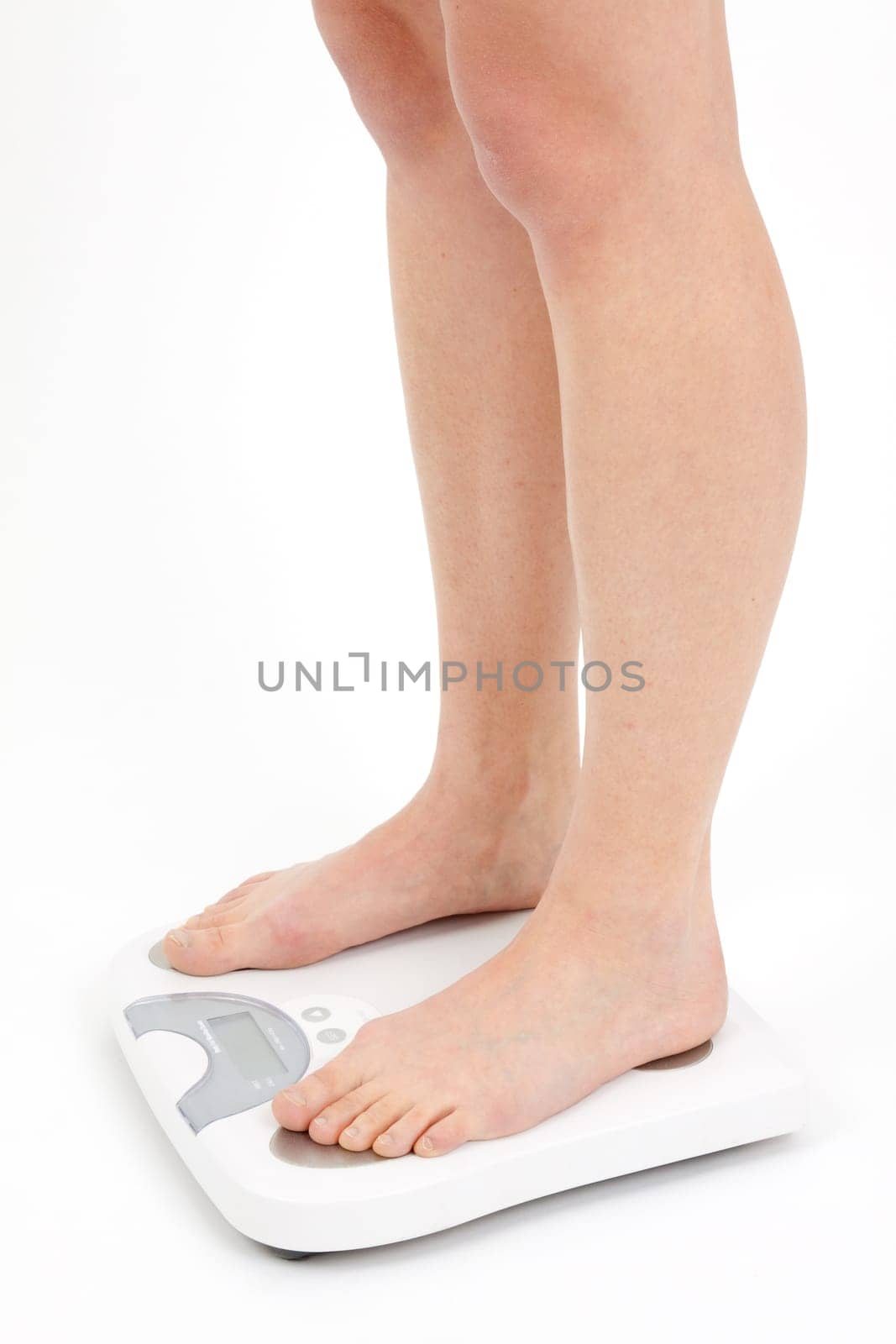 Young woman swaying on a bathroom scale