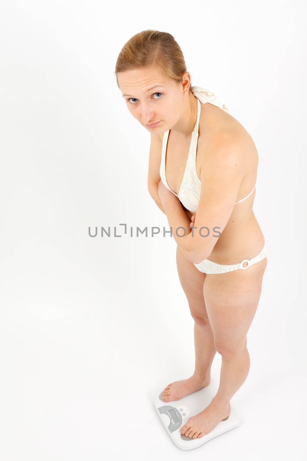 Young woman swaying on a bathroom scale