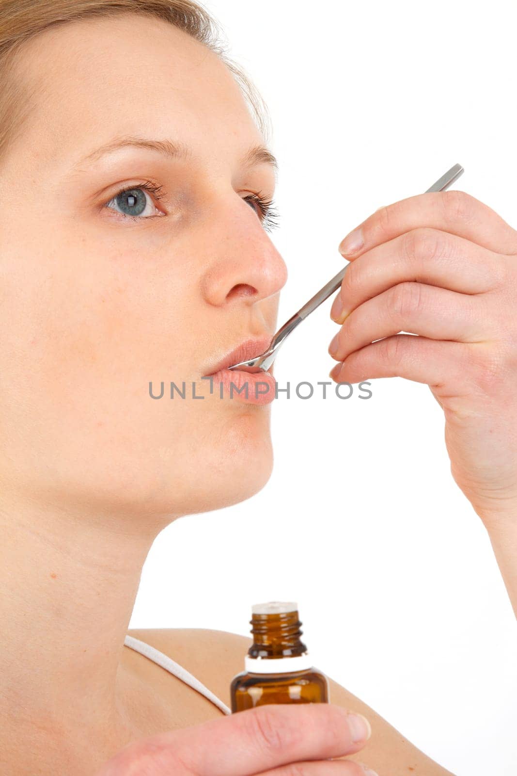Woman taking medical drops