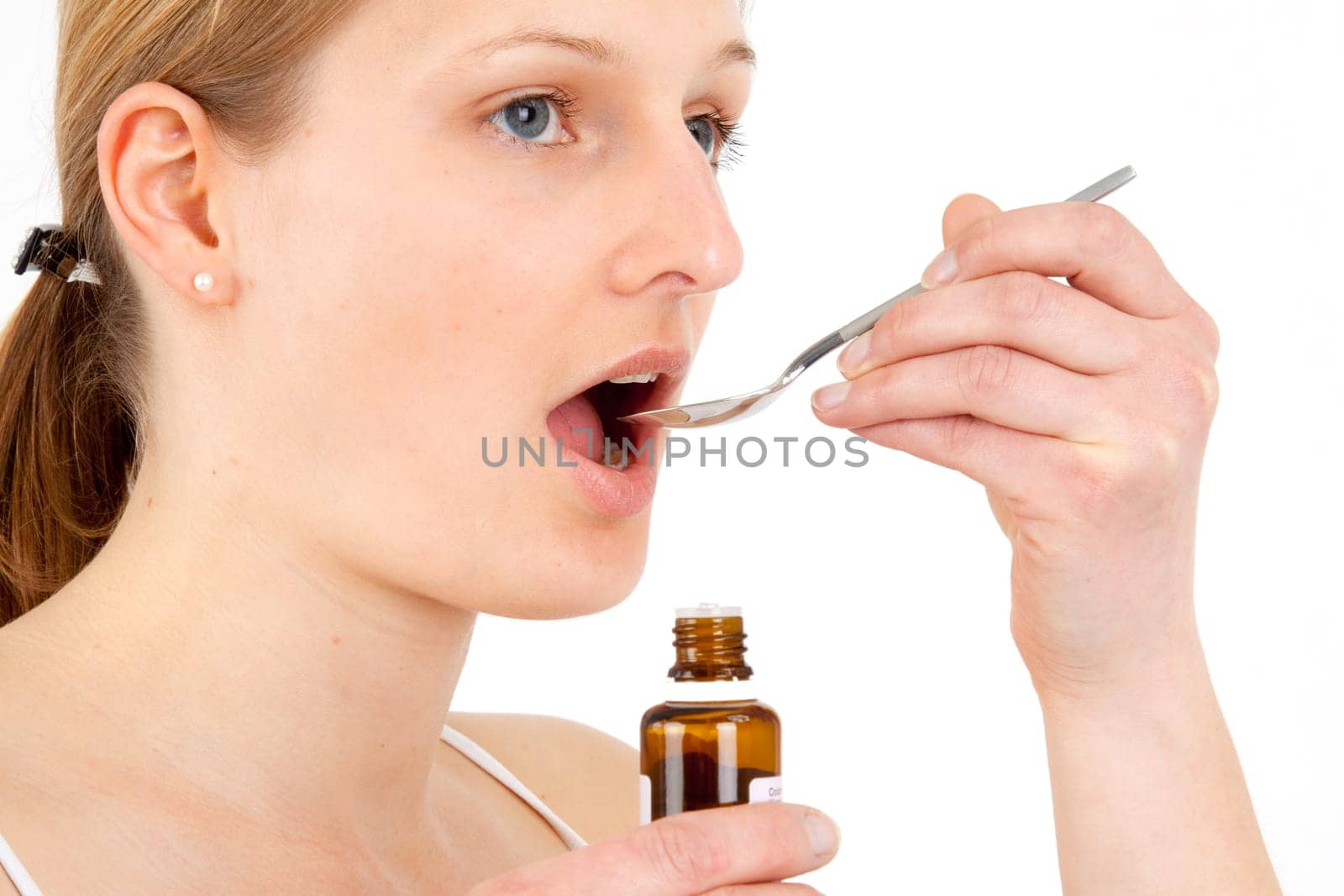 Woman taking medical drops