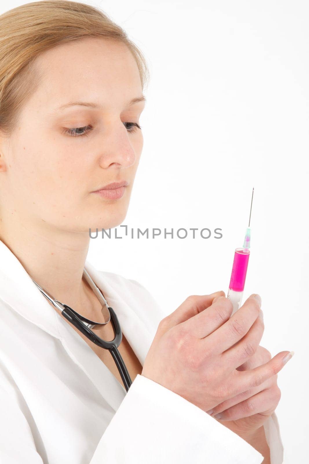Young female doctor or nurse giving injection