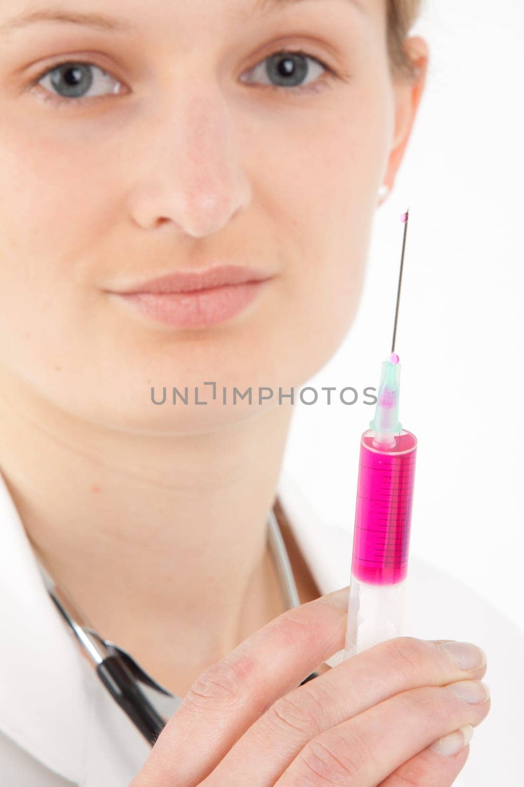 Young female doctor or nurse giving injection