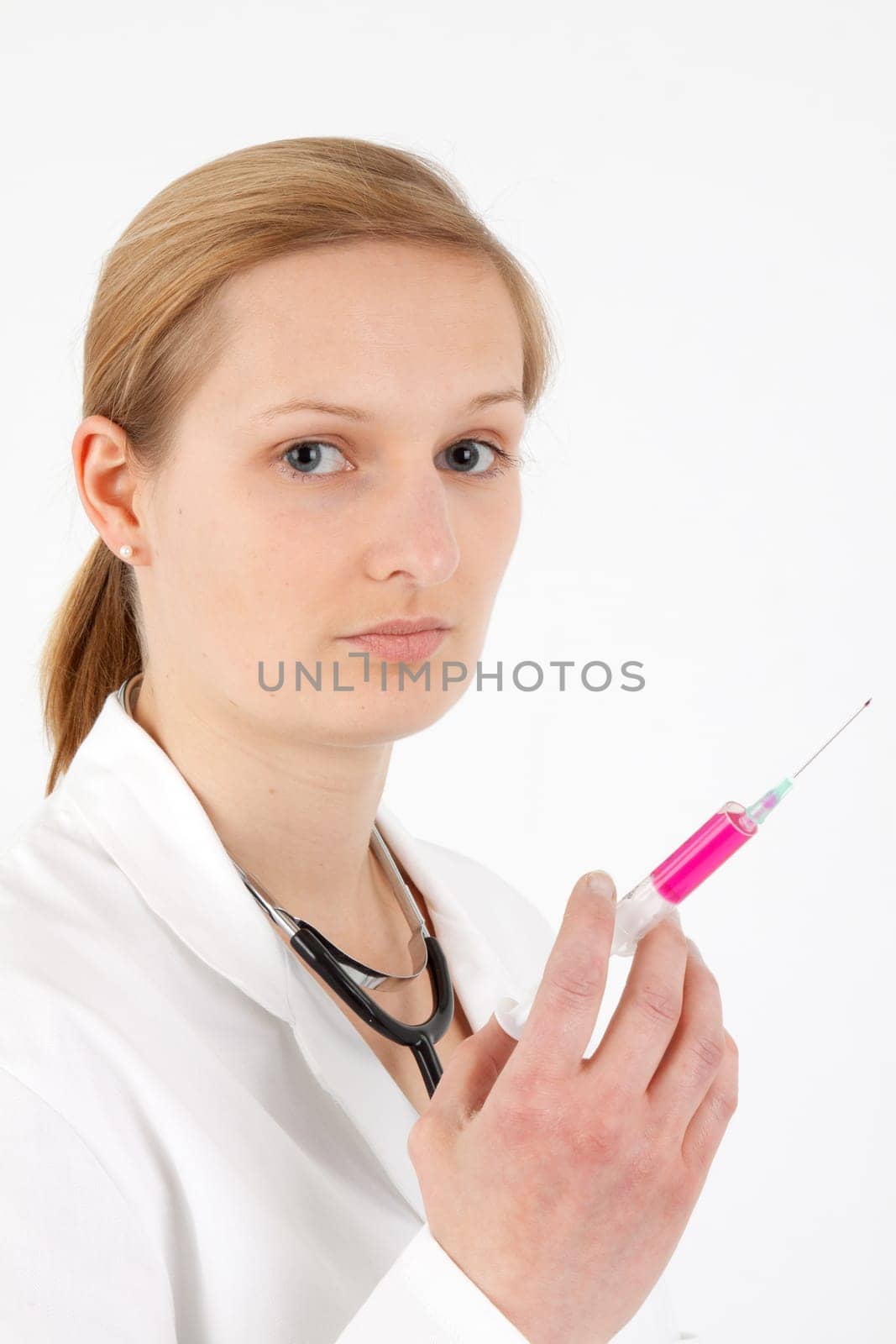 Young female doctor or nurse giving injection