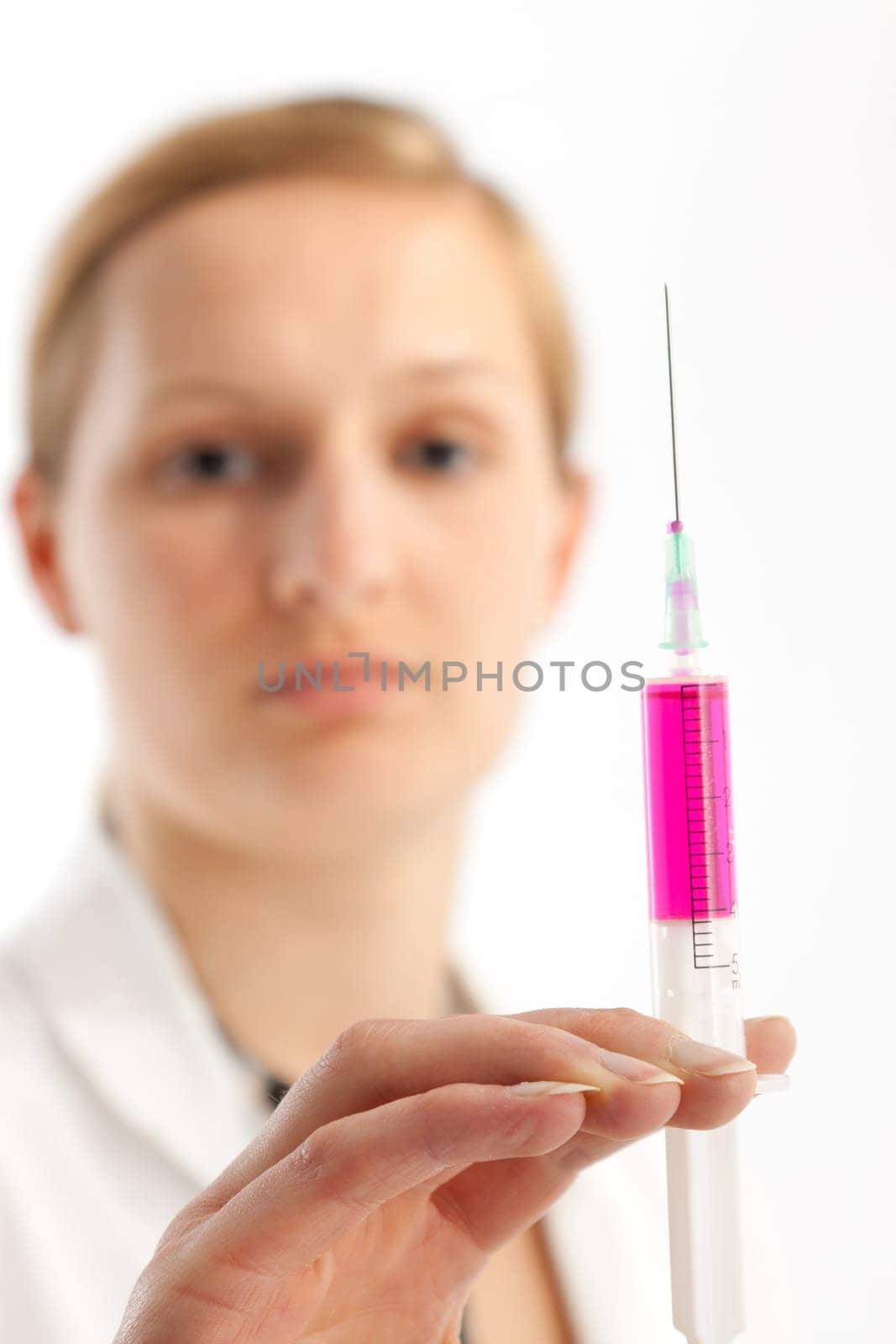 Young female doctor or nurse giving injection