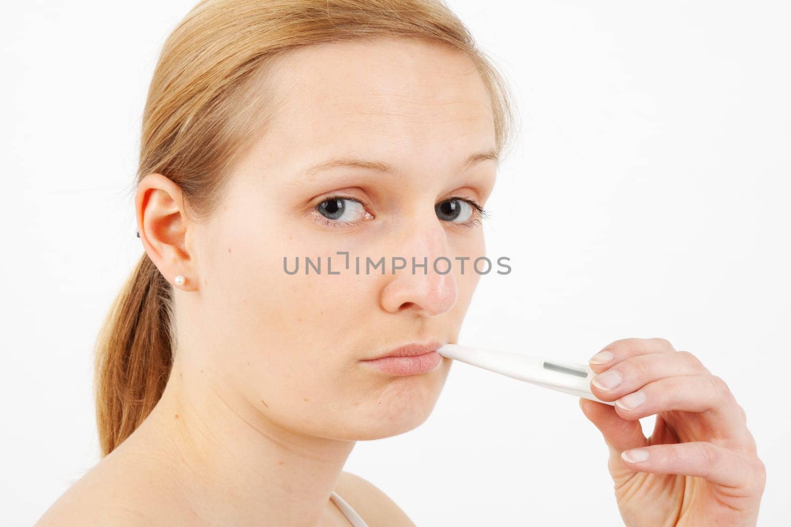 Young woman measuring fever