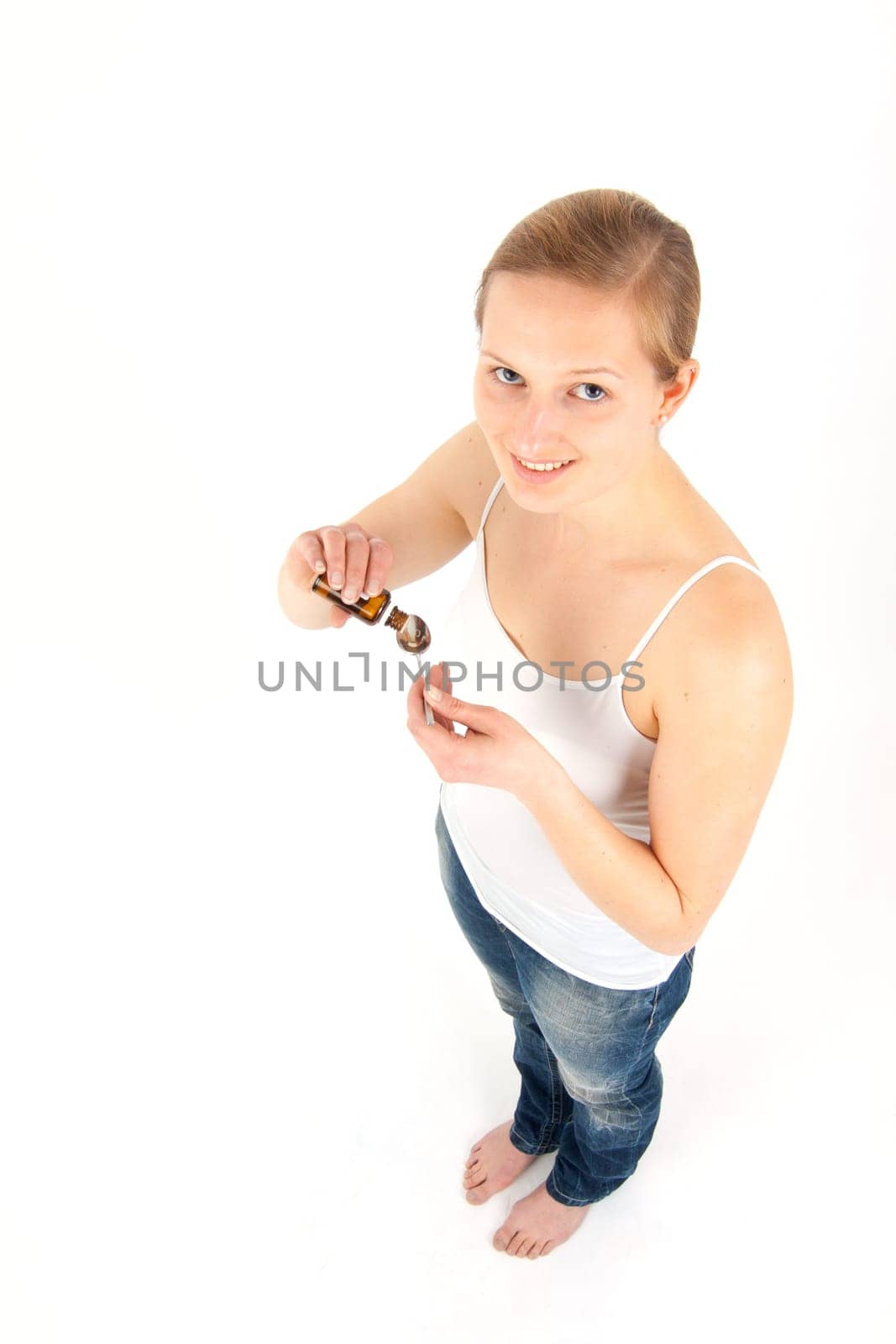 Young woman dripping medicine into a spoon