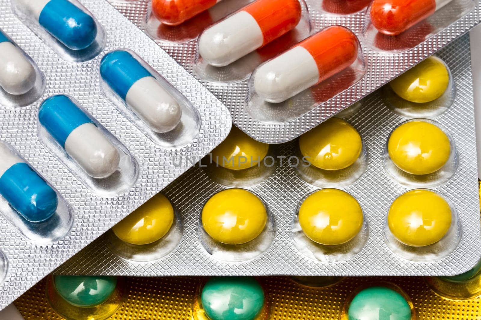 Background of colorful capsules and pills closeup