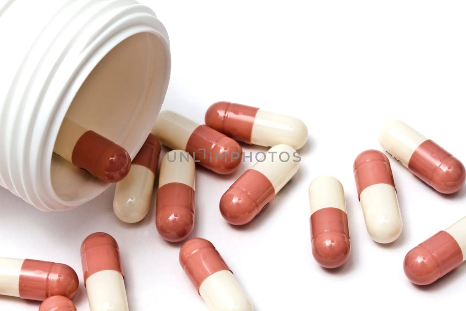 Capsules and bottle isolated on white background